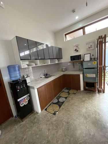 a large kitchen with a sink and a stove at Cozy Home in Bacolod City near Airport & the Ruins in Bacolod