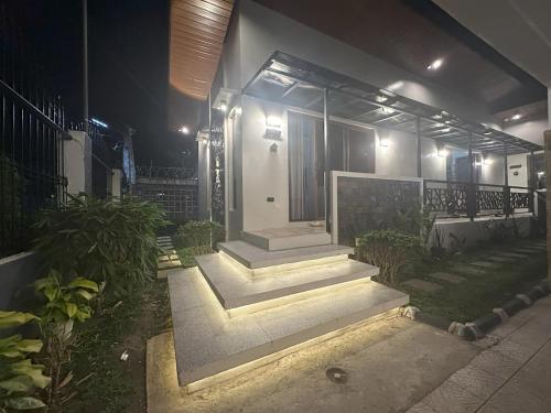 a house with stairs in front of it at night at Cozy Home in Bacolod City near Airport & the Ruins in Bacolod