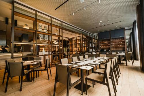 a dining room with a long table and chairs at AC Hotel by Marriott Lima Miraflores in Lima