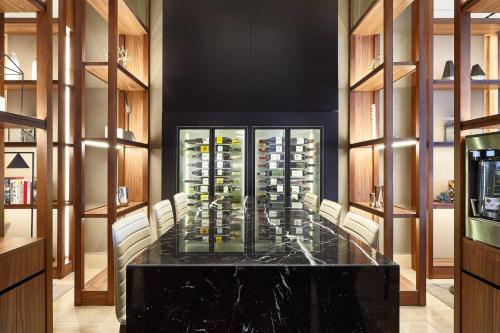 a dining room with a large table with bottles of wine at AC Hotel by Marriott Lima Miraflores in Lima