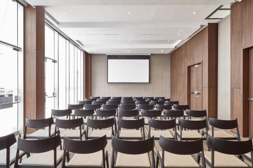 a conference room with chairs and a projection screen at AC Hotel by Marriott Lima Miraflores in Lima