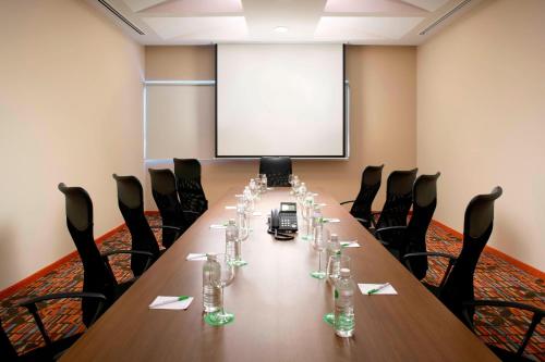 a conference room with a long table with glasses on it at Courtyard by Marriott Hermosillo in Hermosillo