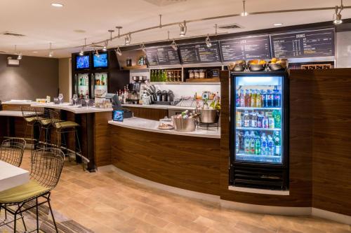 a bar in a restaurant with a refrigerator at Courtyard by Marriott Thousand Oaks Ventura County in Thousand Oaks