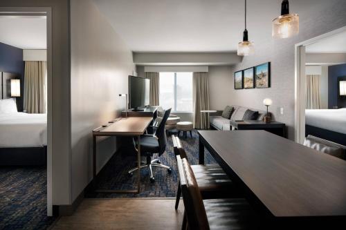a hotel room with a desk and a bedroom at Residence Inn by Marriott Scottsdale Salt River in Scottsdale