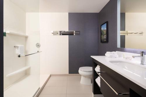 a bathroom with a toilet and a sink and a shower at Residence Inn by Marriott Scottsdale Salt River in Scottsdale