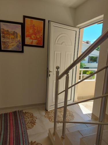 a staircase leading to a white door in a house at Villa Lyudmila in Utjeha