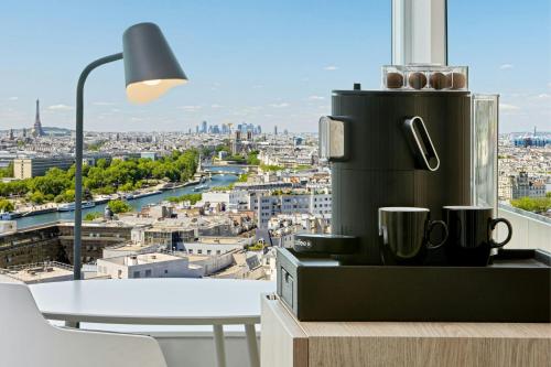a coffee machine on a table with a view of a city at Courtyard by Marriott Paris Gare de Lyon in Paris