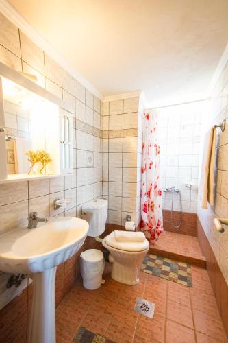 a bathroom with a sink and a toilet and a sink at Mantilida Villa & Studio in Kissamos