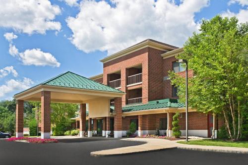 a red brick building with a green roof at Courtyard Parsippany in Parsippany
