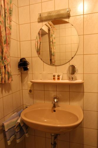 a bathroom with a sink and a mirror at Ferienhaus Andreas in Krün