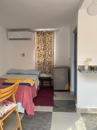 a small room with a bed and a window at Unique Studio in Cairo