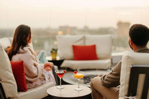a man and woman sitting in a living room with drinks at JW Marriott, Anaheim Resort in Anaheim