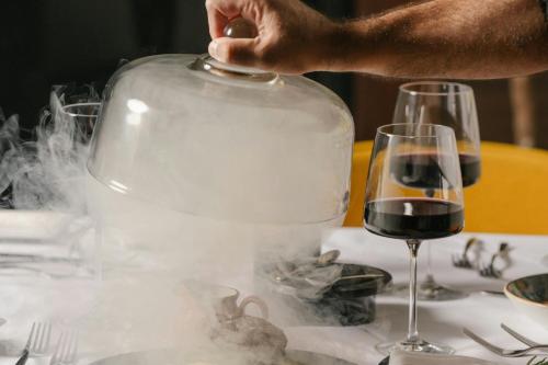 a person is holding a glass of wine on a table at JW Marriott, Anaheim Resort in Anaheim