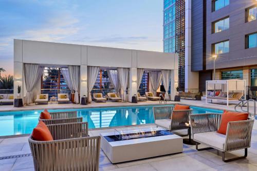 a swimming pool with chairs and a building at JW Marriott, Anaheim Resort in Anaheim