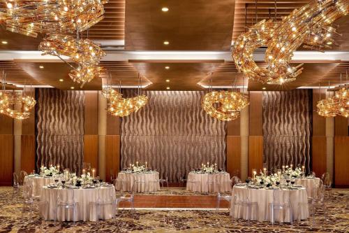 a ballroom with tables and chandeliers at JW Marriott, Anaheim Resort in Anaheim