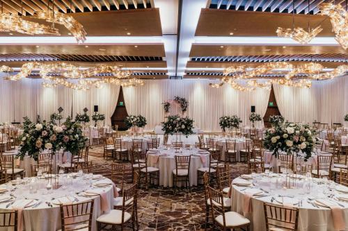 a banquet hall with tables and chairs with flowers at JW Marriott, Anaheim Resort in Anaheim