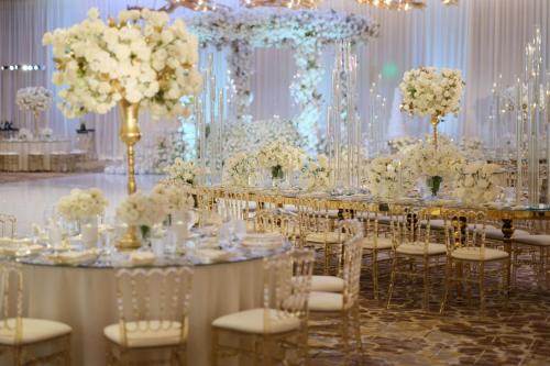 a banquet hall with tables with white flowers and chairs at JW Marriott, Anaheim Resort in Anaheim