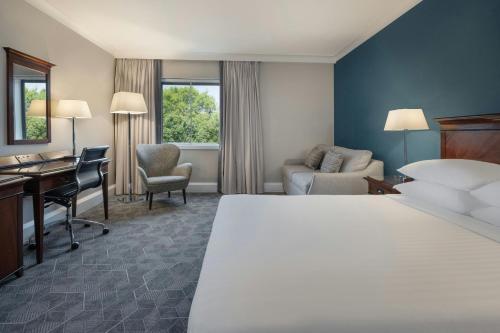 a hotel room with a bed and a desk at Delta Hotels by Marriott Newcastle Gateshead in Newcastle upon Tyne