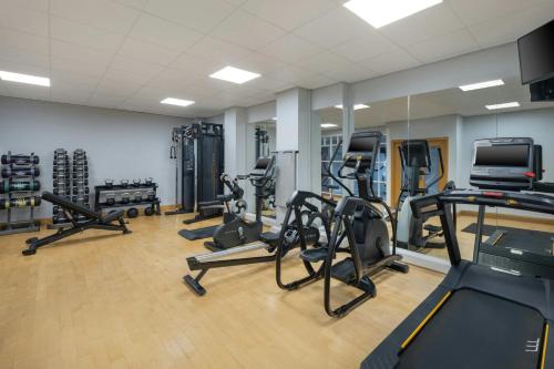 a gym with several treadmills and exercise bikes at Delta Hotels by Marriott Newcastle Gateshead in Newcastle upon Tyne