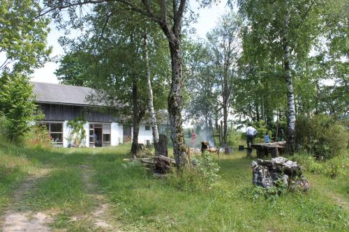 a house in the middle of a field with trees at Hirmhof in Reinsberg