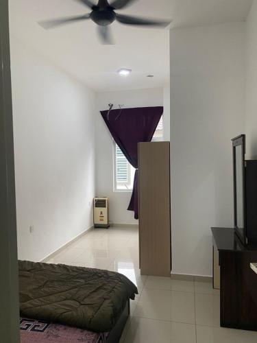a bedroom with a bed and a ceiling fan at Naira Homestay in Bedung