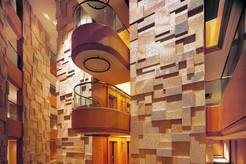 two views of a building with a spiral staircase at Sheraton Ningbo Hotel - Tianyi Square in Ningbo