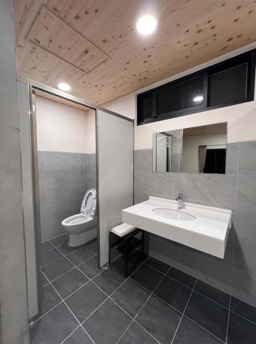 ein Badezimmer mit Waschbecken und Toilette in der Unterkunft Hey Castle B&B in Xiaoliuqiu