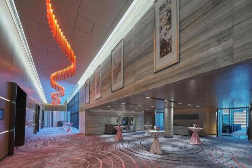 a rendering of a lobby with tables and artwork at Aloft Singapore Novena in Singapore