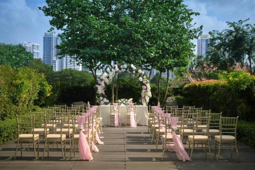a row of chairs and tables with pink bows at Aloft Singapore Novena in Singapore