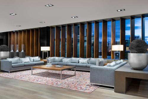 a living room with couches and a table at AC Hotel Oviedo Fórum by Marriott in Oviedo