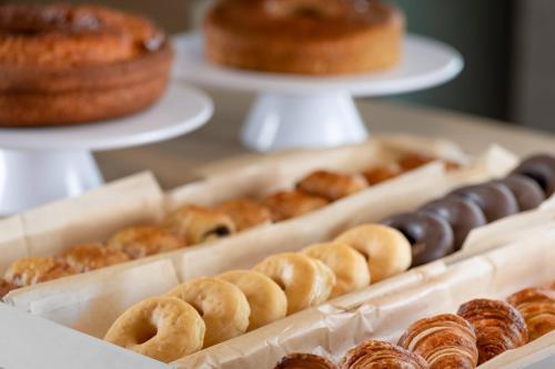 a display of different types of donuts on a table at AC Hotel Oviedo Fórum by Marriott in Oviedo