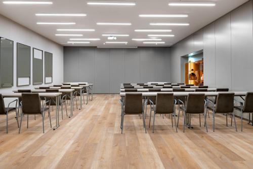 a conference room with tables and chairs in it at AC Hotel Oviedo Fórum by Marriott in Oviedo