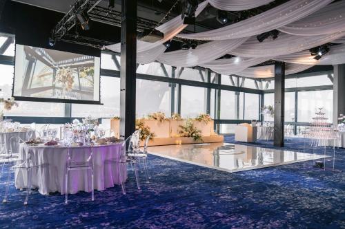 a banquet hall with tables and chairs in a building at Pier One Sydney Harbour, Autograph Collection in Sydney