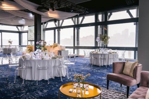 a room with two tables with white tablecloths at Pier One Sydney Harbour, Autograph Collection in Sydney