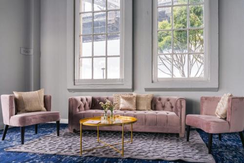 a living room with two couches and a table at Pier One Sydney Harbour, Autograph Collection in Sydney