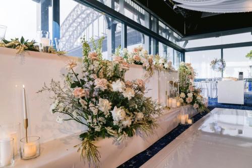 a table with a bunch of flowers and candles at Pier One Sydney Harbour, Autograph Collection in Sydney