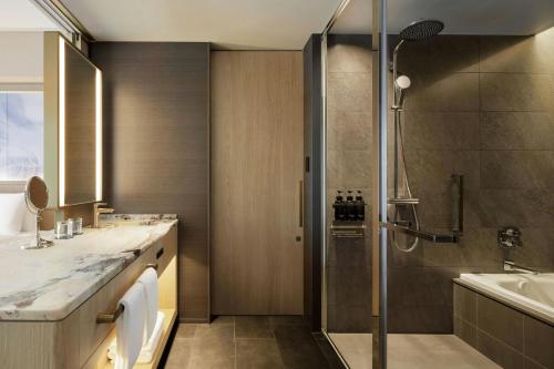 a bathroom with a shower and a sink at THE OSAKA STATION HOTEL, Autograph Collection in Osaka