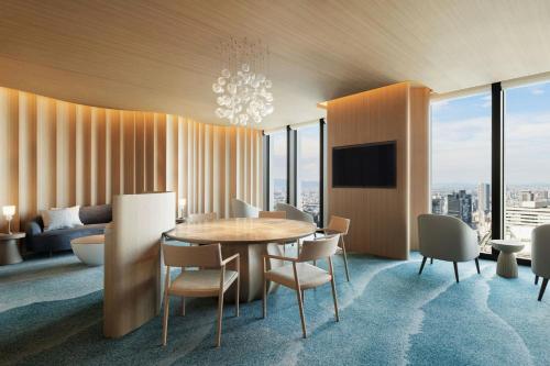 a dining room with a table and chairs at THE OSAKA STATION HOTEL, Autograph Collection in Osaka