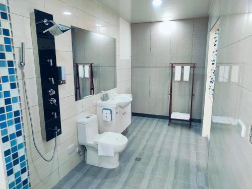 a bathroom with a toilet and a sink and a shower at 藍月金門民宿 in An-ch'ien