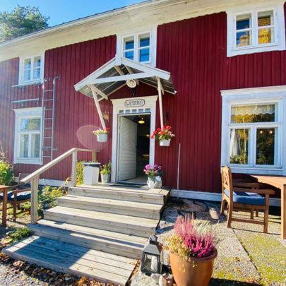 a red house with a staircase leading to the door at Wästinn in Vöyri