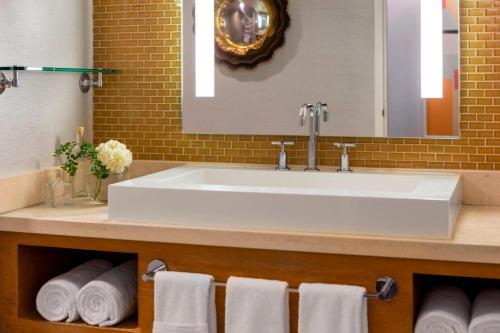 a bathroom with a white sink and towels at Renaissance Palm Springs Hotel in Palm Springs