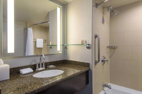 a bathroom with a sink and a shower at Renaissance Palm Springs Hotel in Palm Springs