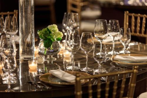 a table with wine glasses and plates and candles at Renaissance Palm Springs Hotel in Palm Springs