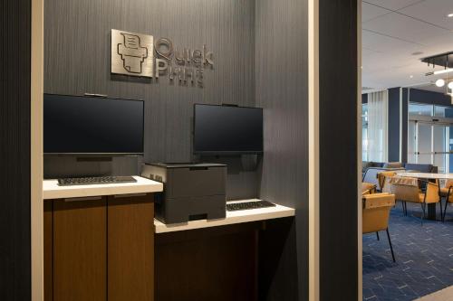 an office with two monitors and a computer on a desk at Courtyard by Marriott Fresno Clovis in Clovis