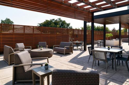 a patio with tables and chairs on a patio at Courtyard by Marriott Fresno Clovis in Clovis