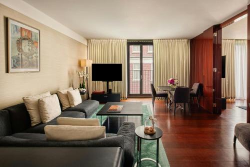a living room with a couch and a table at Bvlgari Hotel London in London