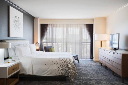 a hotel room with a bed and a television at Renaissance Raleigh North Hills Hotel in Raleigh