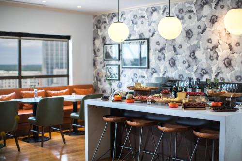 a restaurant with a table with food on it at Renaissance Raleigh North Hills Hotel in Raleigh