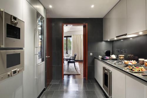 a kitchen with black walls and a counter top at Bvlgari Hotel London in London