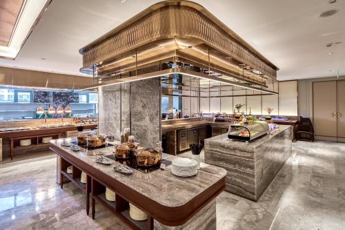 a large kitchen with a large island in the middle at Mercure Yiwu International Trade City in Yiwu